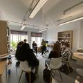 A-Level students sit in a circle while a researcher speaks