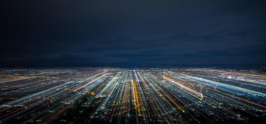A city at night with blurred light trails