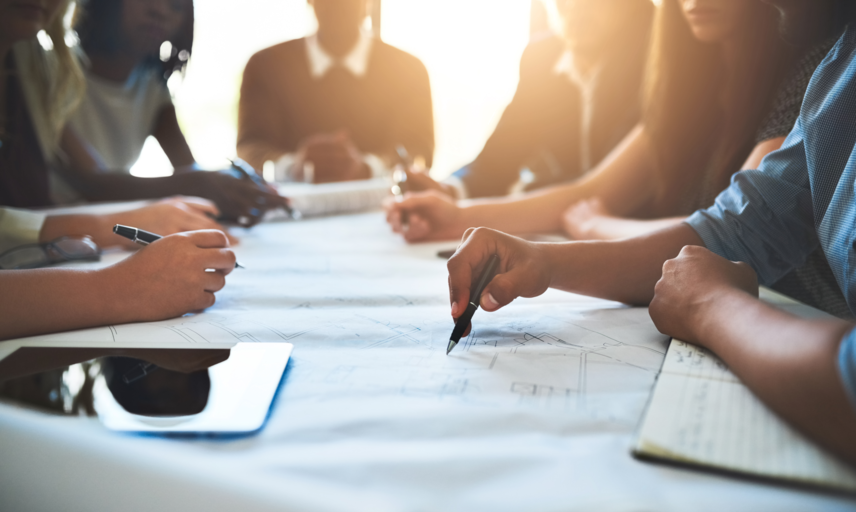 Several people work collaboratively at a table