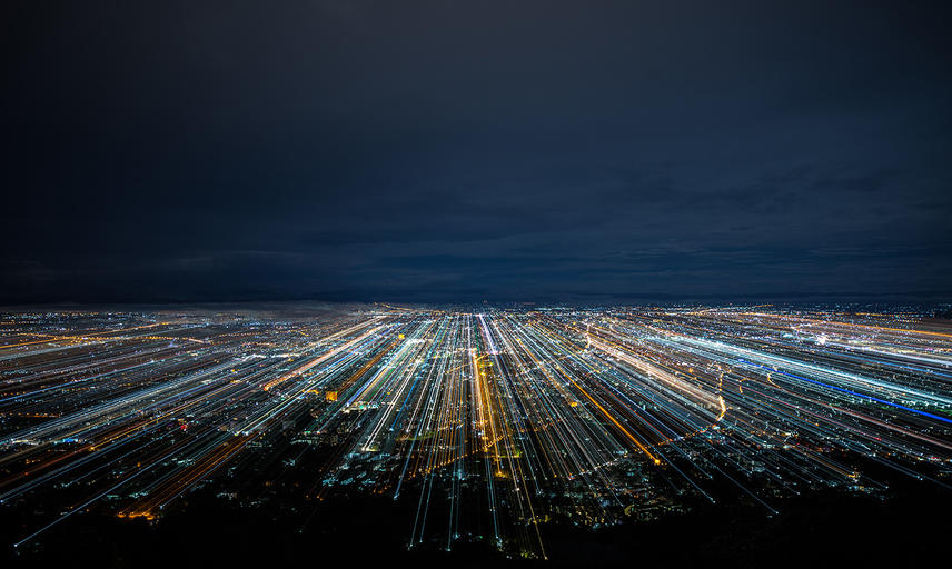 A city at night with blurred light trails
