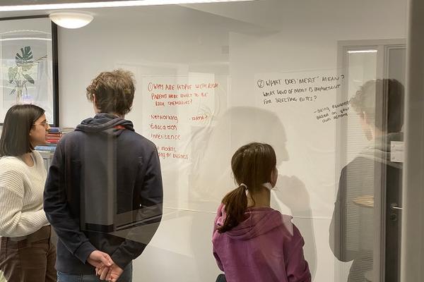 A-Level students looking at whiteboard
