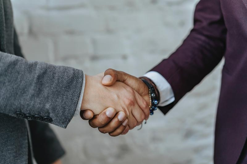 Two people shake hands