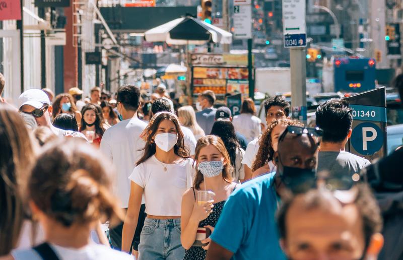 Image of crowd on a street wearing masks