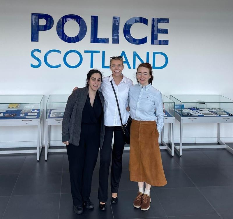 Helen and two colleagues pose for a photo outside a sign for Police Scotland 