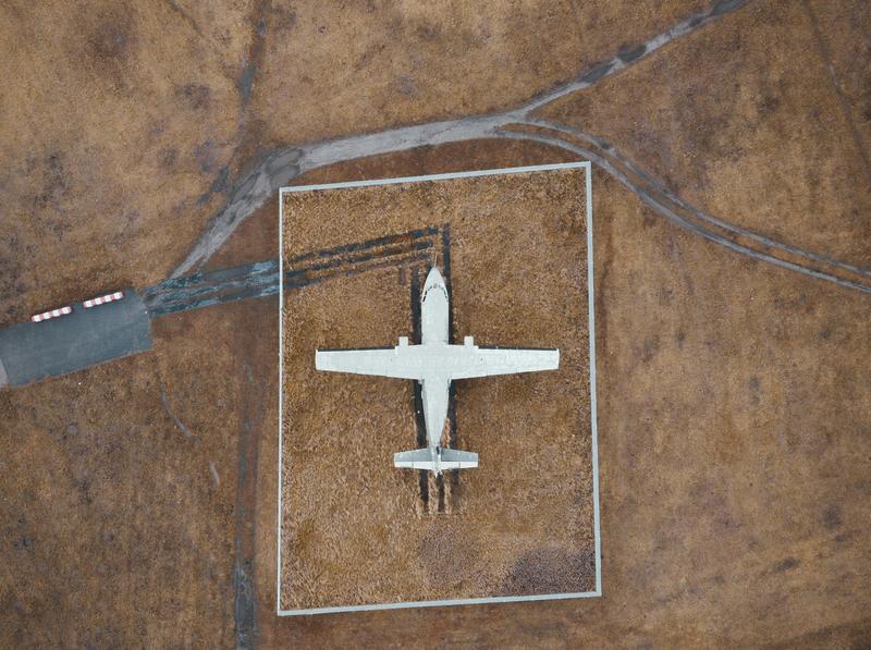Aerial image of small plane on airstrip