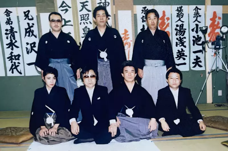 Seven members of a yakuza gang pose for a picture, including Nichimura Mako, the only woman to ever formally join a yakuza gang as a full member