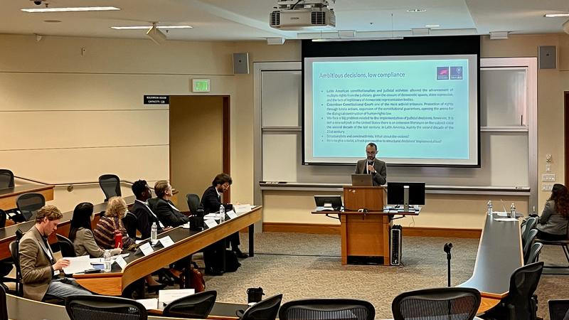 Julián presents his work in front of an audience at Stanford University 