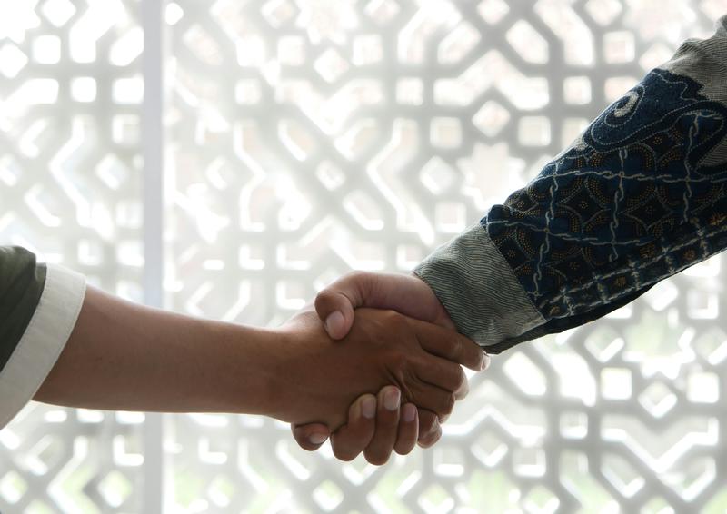 Image of two people shaking hands