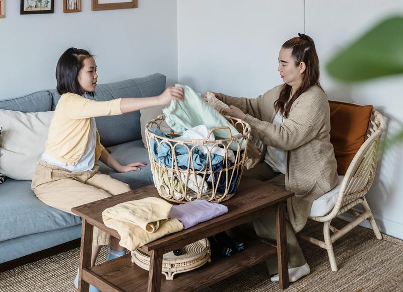 Image of woman and girl sorting laundry 