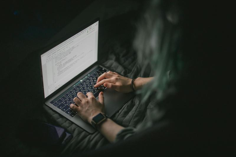 Image of individual typing on laptop