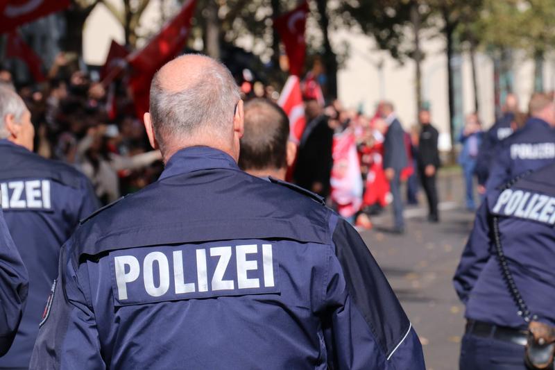 The Polizei, German police officers, walk away from the camera