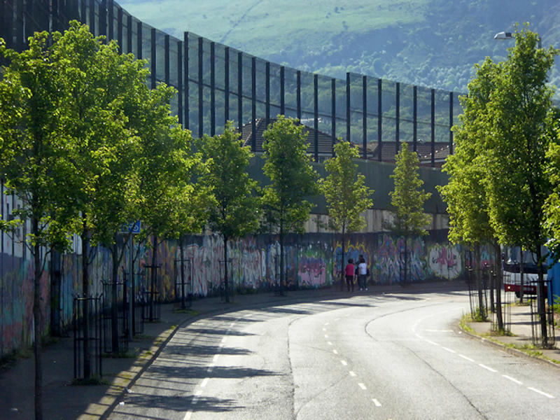 Image of Peace Wall alongside Cupar Way road in Belfast