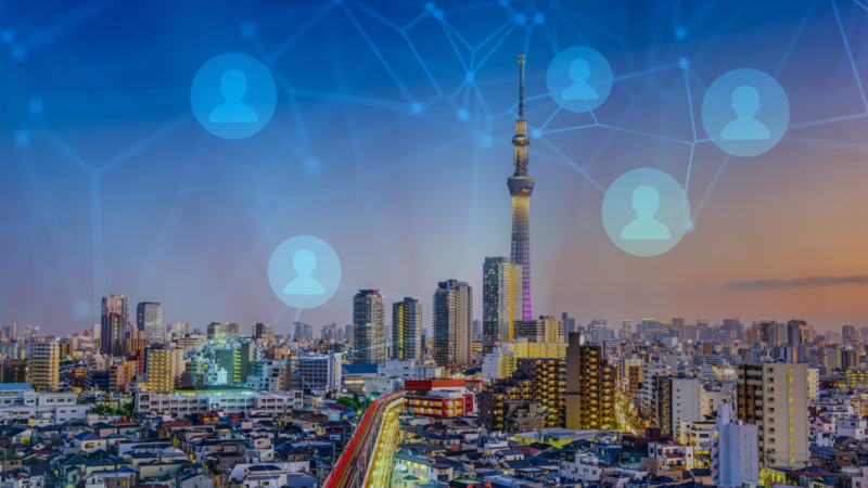 Image of Japanese city skyline overlaid with network graphic 