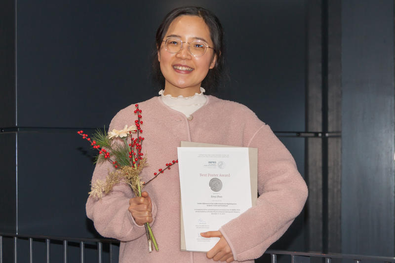 Xinyi Zhao holds the certificate of her award from the Max Planck Institute for Demographic Research
