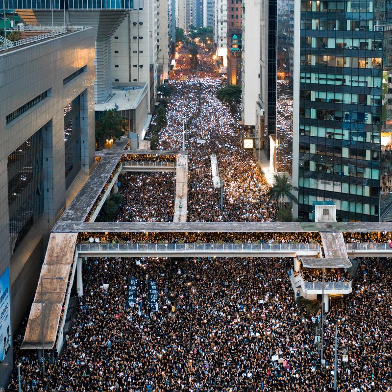 Crowds of people fill the street during a protest in Hong Kong