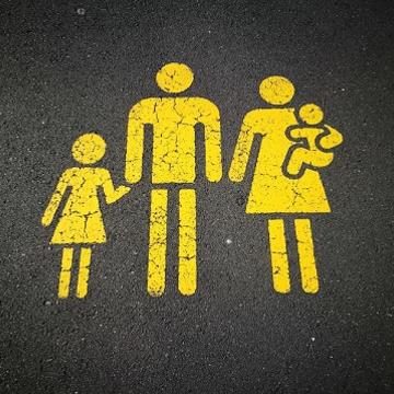 Photo of yellow family parking sign on road
