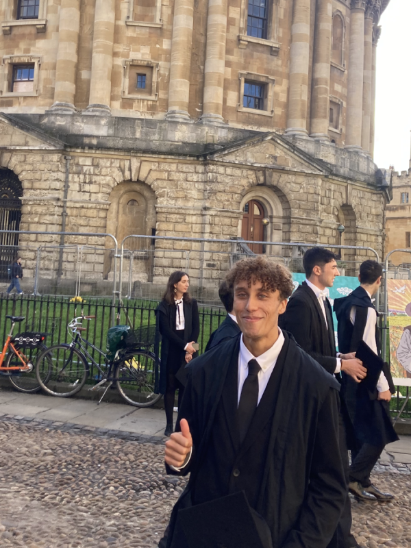 Image of Samuel Birch in front of the Radcliffe Camera at matriculation 