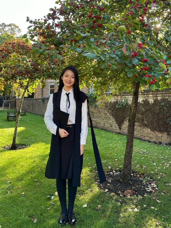 Image of Yanjing Lu in a garden at Kellogg College on the day of her Matriculation Ceremony
