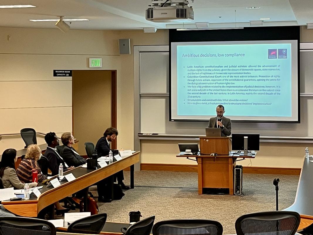 Julián presents his work in front of an audience at Stanford University 