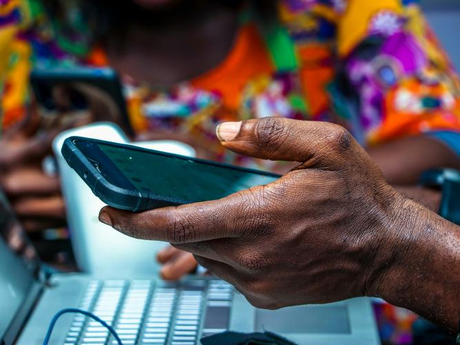Image of someone holding a mobile phone