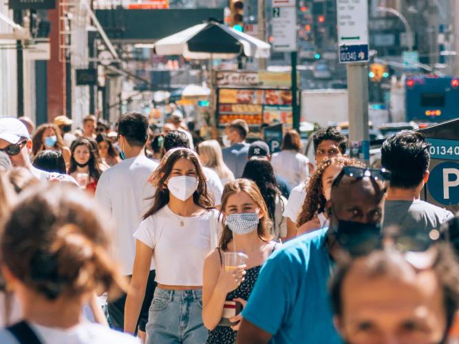 Image of crowd on a street wearing masks