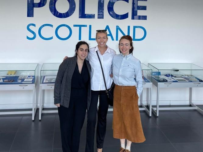 Helen and two colleagues pose for a photo outside a sign for Police Scotland 