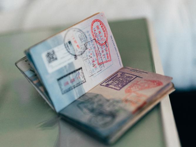 An open passport showing stamps from various countries