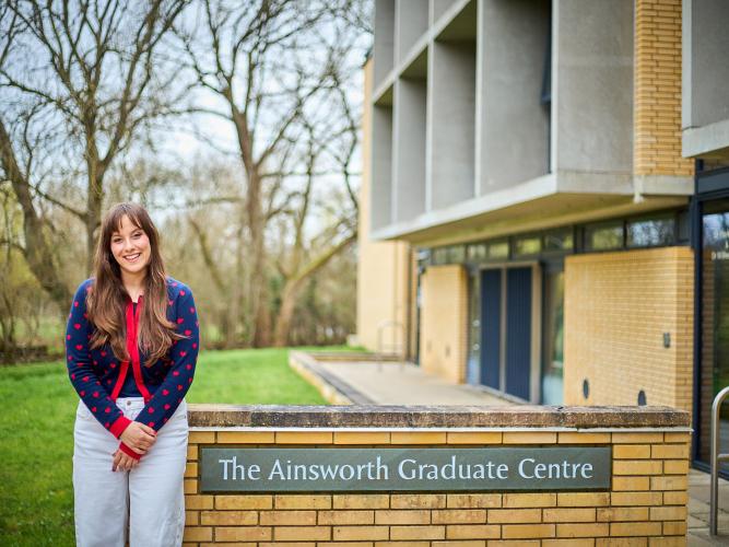 Image of Emma Somos outside of the Ainsworth Graduate Centre