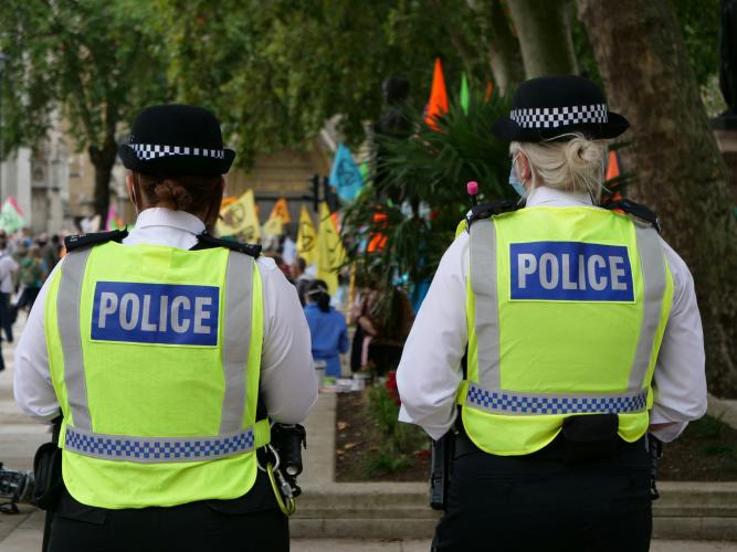 Image of two police officers facing away from the camera