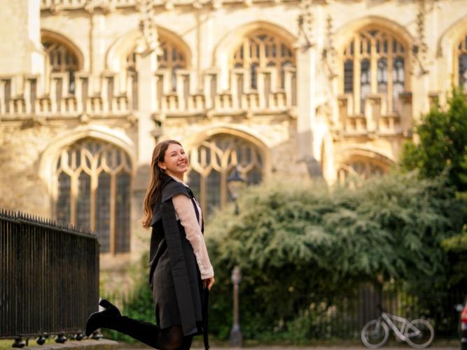 Image of Sarah Brand standing in Radcliffe Square after her Matriculation Ceremony