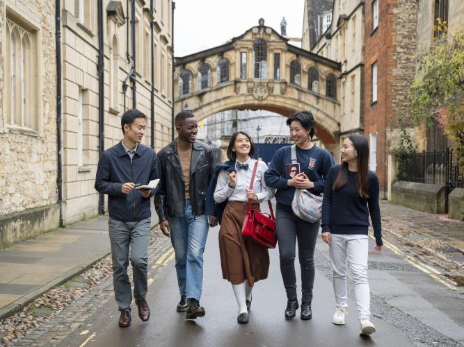 Image of five students walking underneath Oxford's Bridge of Sighs