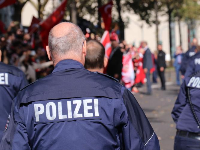 The Polizei, German police officers, walk away from the camera