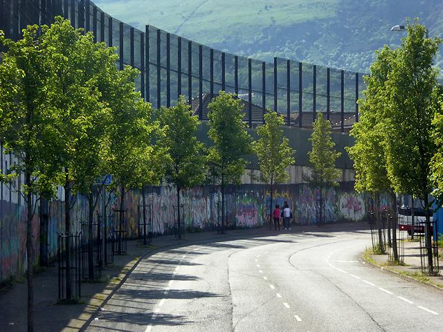 Image of Peace Wall alongside Cupar Way road in Belfast