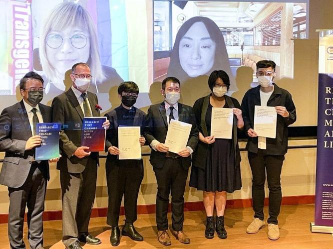 Yiu-tung Suen stands with five other people, presenting research from the Sexualities Research Programme