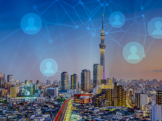 Image of Japanese city skyline overlaid with network graphic 