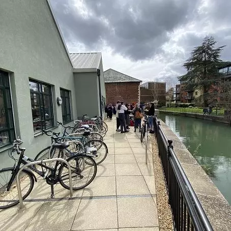 The students gather next to bike parking beside the Department building