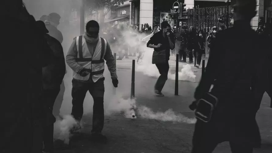 Black & white image of protesters and police