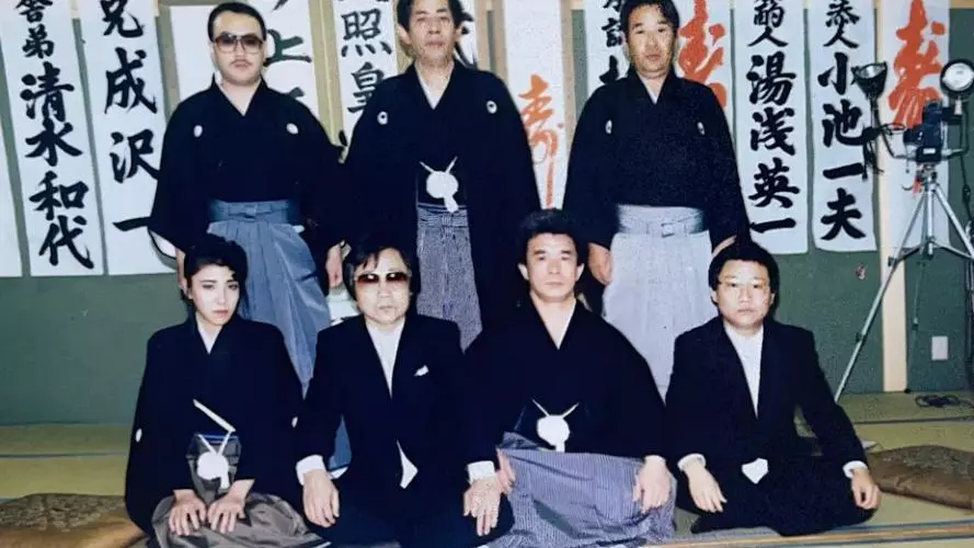 Seven members of a yakuza gang pose for a picture, including Nichimura Mako, the only woman to ever formally join a yakuza gang as a full member