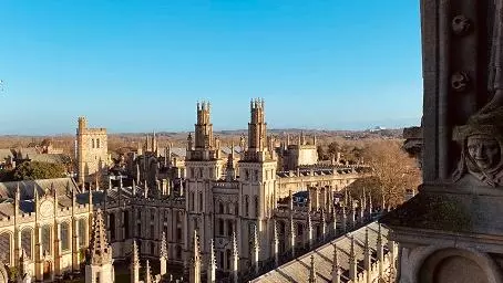 University of Oxford buildings against a clear blue sky