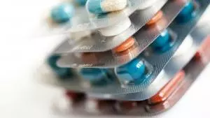 Different coloured pills in packets