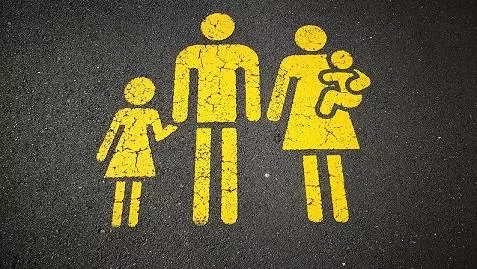 Photo of yellow family parking sign on road