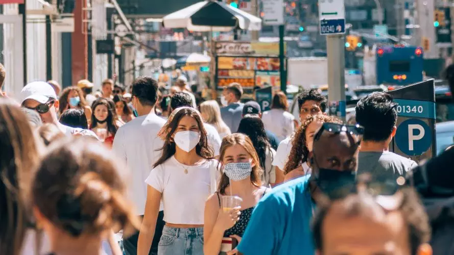 Image of crowd on a street wearing masks