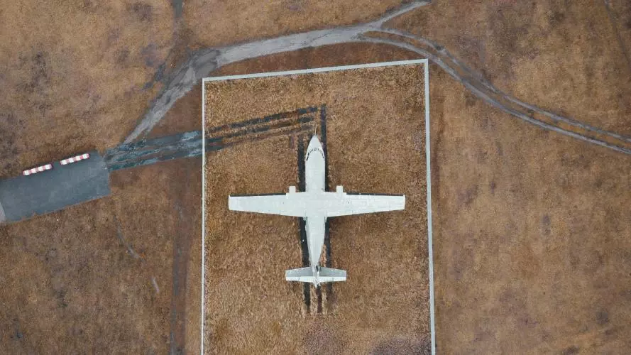 Aerial image of small plane on airstrip