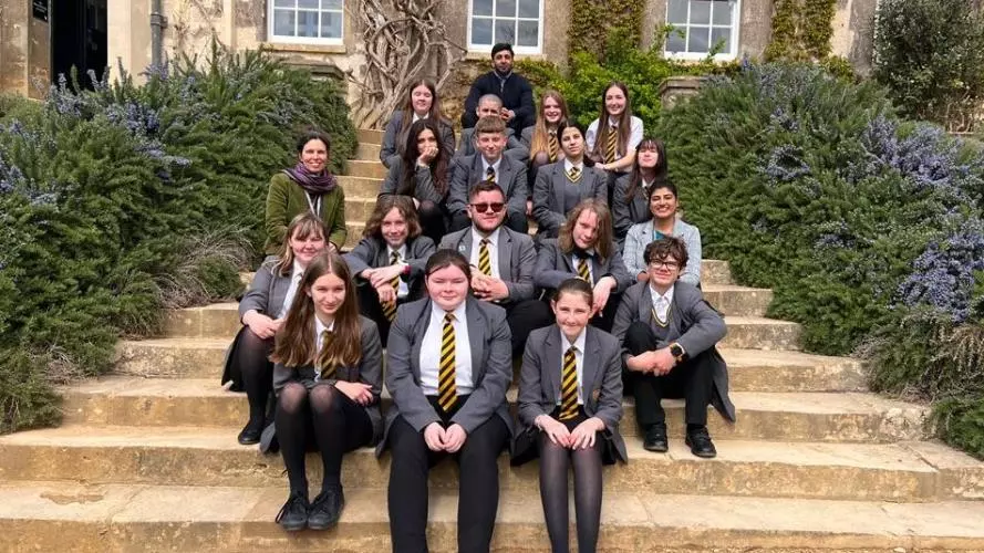 Students and teachers sit on the steps at Worcester College