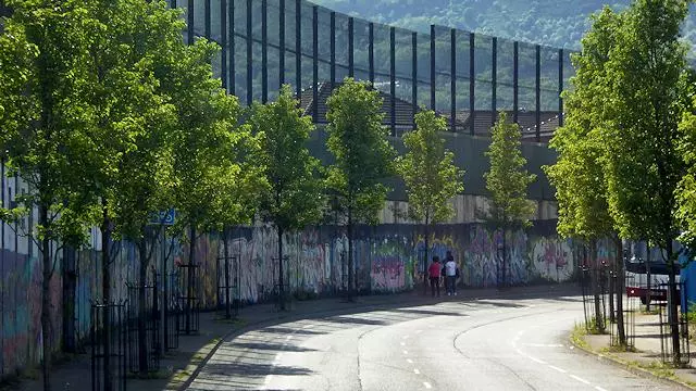 Image of Peace Wall alongside Cupar Way road in Belfast
