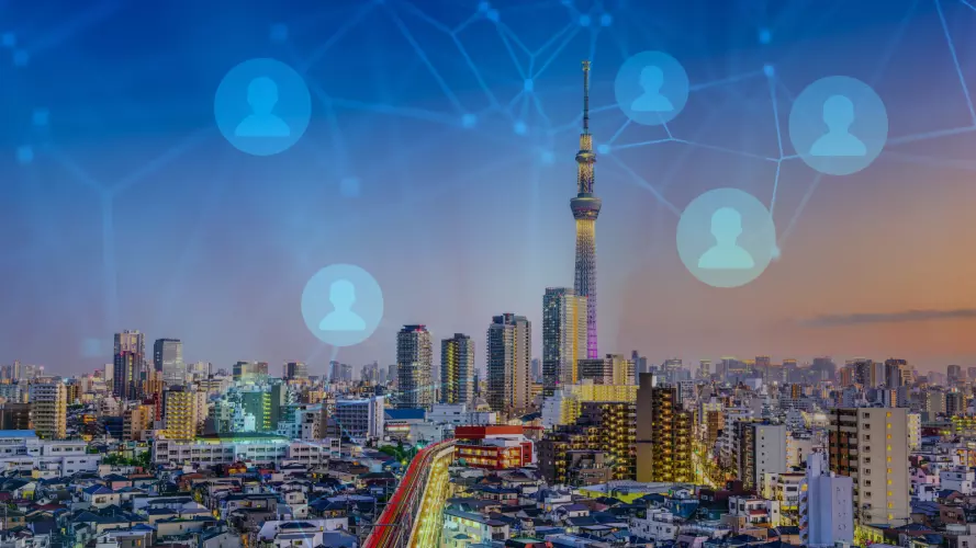 Image of Japanese city skyline overlaid with network graphic 