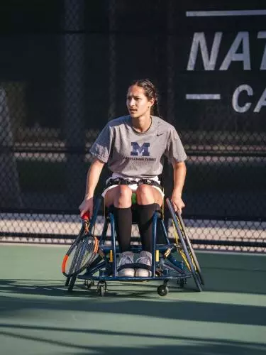 Image of Dakota J Betts playing wheelchair tennis