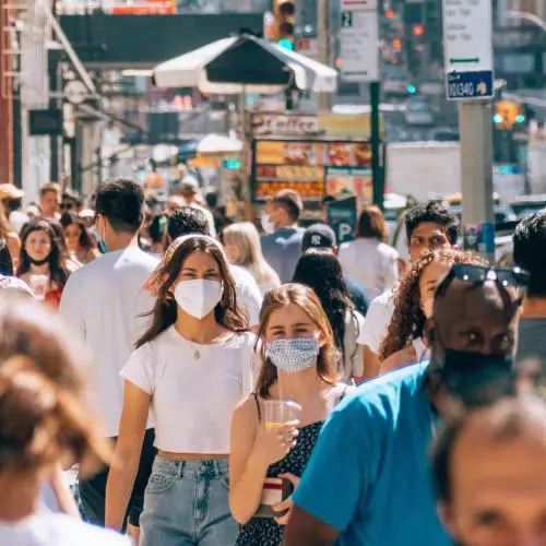 Image of crowd on a street wearing masks