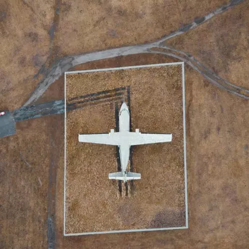 Aerial image of small plane on airstrip