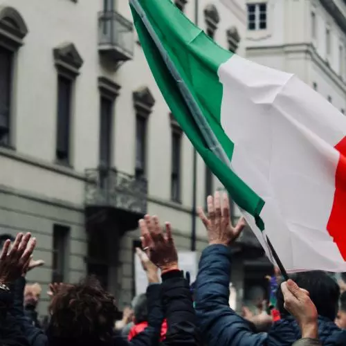 A crowd hold up a Italian flag in Torino, Italy